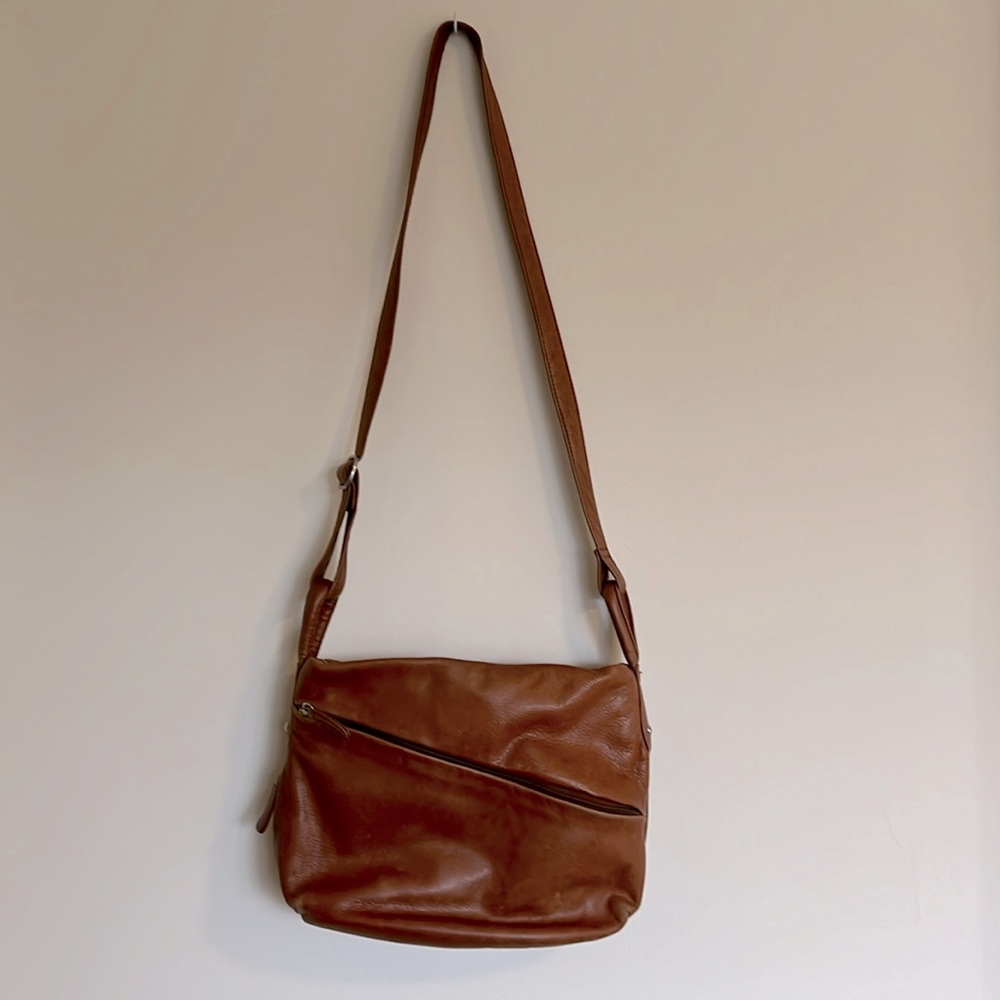 Cognac brown leather bag with asymmetrical zipper